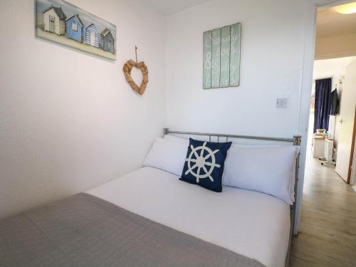 a bedroom with a bed with a pillow on it at Chalet 58 - The Beach House in Deal