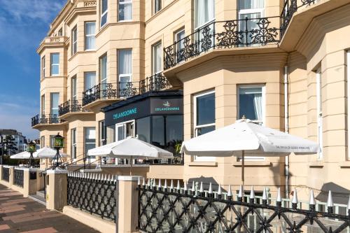 a row of white umbrellas in front of a building at The Lansdowne, Eastbourne in Eastbourne