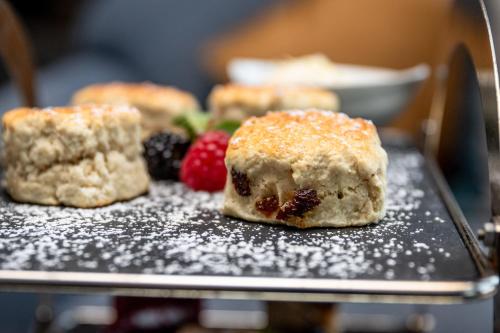 a tray with some pastries and berries on it at The Lansdowne, Eastbourne in Eastbourne
