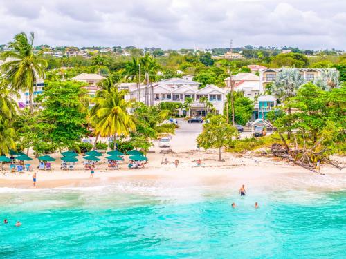 an aerial view of a beach with people in the water at Blue Horizon Hotel in Bridgetown