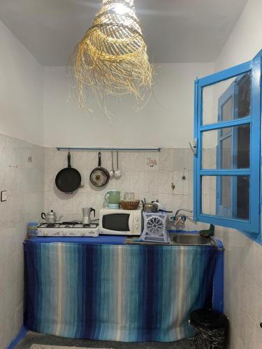 a kitchen with a blue counter and a sink at Atelier Xauen in Chefchaouene