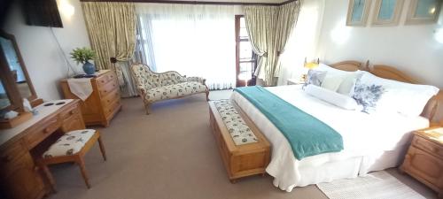 a bedroom with a large bed and a window at Ocean Grove Guesthouse in Port Edward