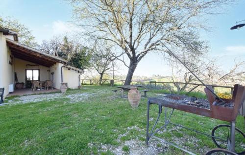 a backyard with a grill and a table and a tree at Stunning Home In Spoleto in Spoleto