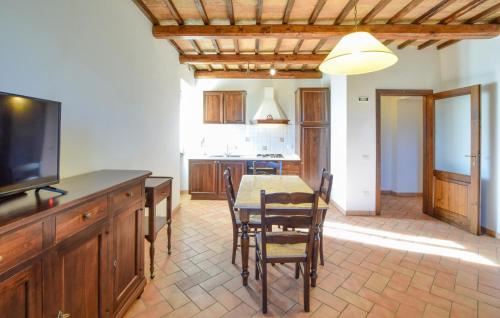a kitchen and dining room with a table and a television at Stunning Home In Spoleto in Spoleto