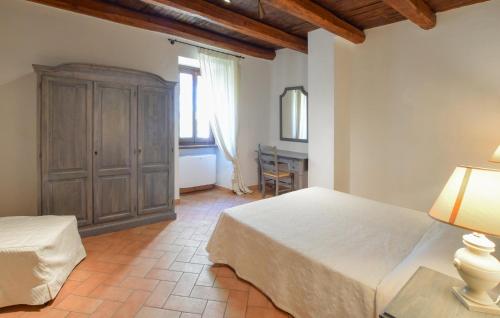 a bedroom with a bed and a cabinet and a table at Stunning Home In Spoleto in Spoleto
