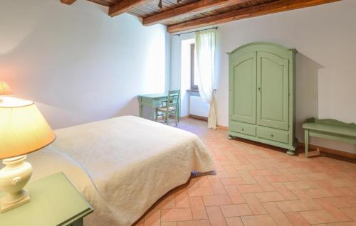 a bedroom with a white bed and a green cabinet at Stunning Home In Spoleto in Spoleto