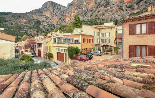 an old town with a mountain in the background at Lovely Home In Moustiers-Sainte-Marie in Moustiers-Sainte-Marie