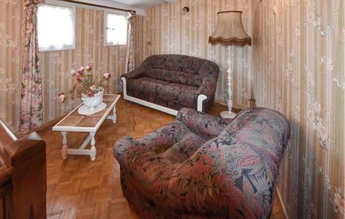 a living room with a couch and a chair at Lovely Home In Moustiers-Sainte-Marie in Moustiers-Sainte-Marie