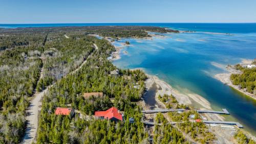 an aerial view of a house on a island in the water at 45 Degrees North - Tobermory in Tobermory