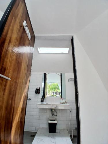 a bathroom with a sink and a mirror at Grace Hill Villa Lubuk Minturun in Padang