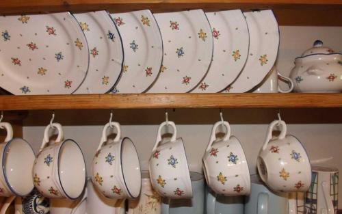 a group of plates and tea pots on a shelf at Taigh Aonghais in Tarskavaig