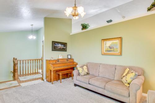 a living room with a couch and a piano at 5 Mi to Downtown Logan Scenic Retreat with Patio in North Logan