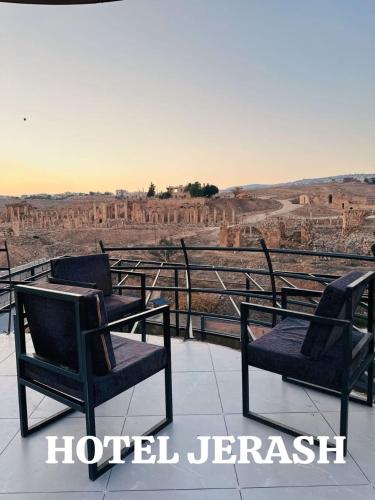 a group of chairs sitting on top of a overlook of a canyon at Jerash Hotel in Jerash