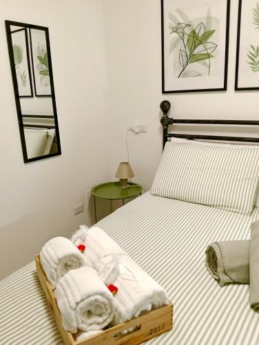a bedroom with a bed with towels on it at Lake Como PORTO VECCHIO in Domaso