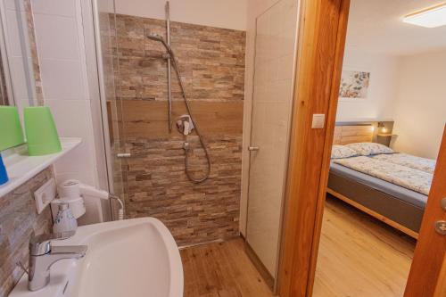 a bathroom with a shower and a sink and a toilet at Schönes Apartment mit 80qm in Senales