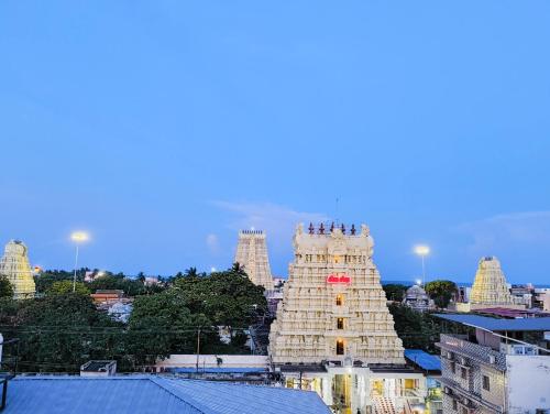 a group of people standing on top of a building at Hare Rama Hare Krishna - EESHA Hotel in Rāmeswaram