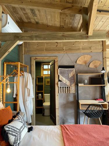 a bedroom with a bunk bed and a bathroom at Vila dos Cedros in Rio dos Cedros