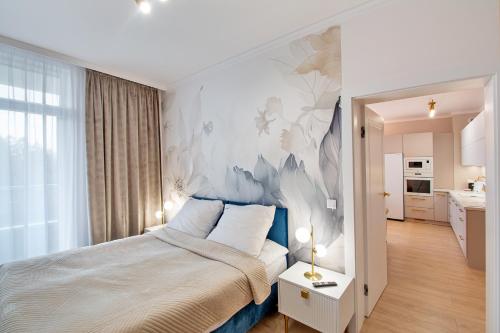 a bedroom with a large bed with a mural on the wall at Aparts Care Beztroski Apartament Ku Morzu in Sianozety
