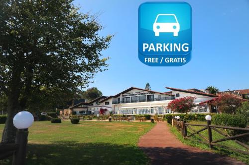 a building with a sign that reads parking free tenants at Hotel Gudamendi in Donostia-San Sebastián
