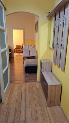 a bedroom with a bed and a dining room with a table at Piac Kuckó Apartman in Debrecen