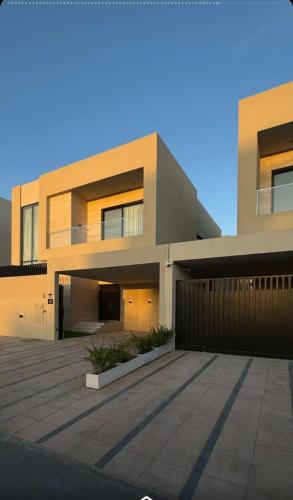 a large house with a parking lot in front of it at Villa 22 in Ajman 