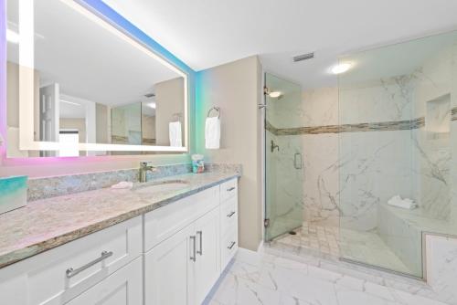 a bathroom with a shower and a sink and a tub at Pine Cove 403C in Sanibel