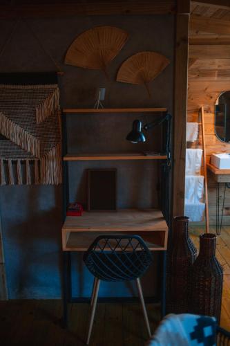 a desk and a chair in a room with a bunk bed at Vila dos Cedros in Rio dos Cedros