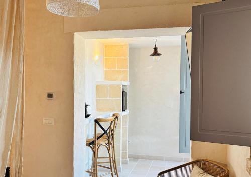 a dining room with a table and chairs in a room at Luxury Suite & Spa Trullo Monte Farella in Putignano