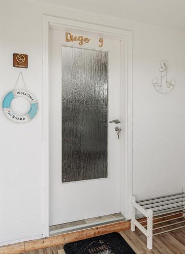 a door with a sign that reads dvice on it at Ferienhäuser Insel Usedom Haus Diego 9 - Blick aufs Achterwasser! Whirlpool und Sauna in Lütow