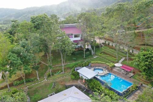 an aerial view of a house with a swimming pool at Grace Hill Villa Lubuk Minturun in Padang