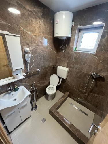 a bathroom with a toilet and a sink at Motel Aura in Mostar