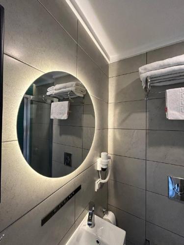 a bathroom with a mirror and a sink at Havana Apart Hotel in Alanya