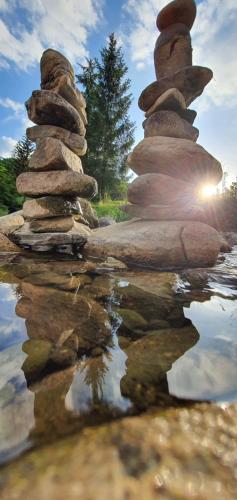 a stack of rocks sitting on top of a body of water at Apartma Tomažič in Hrušica