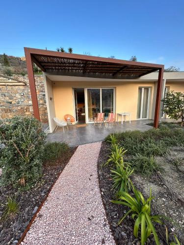 a house with a patio with chairs and tables at Alloggi CH40 in Imperia