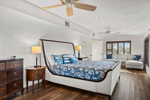 a bedroom with a bed with a ceiling fan at Fantasea in Sanibel