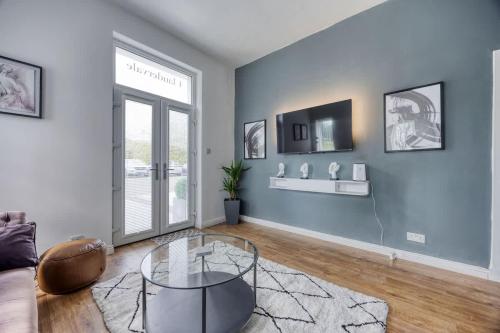 a living room with a glass table and a couch at 2 Bedroom in the Heart of Loch Lomond in Balloch