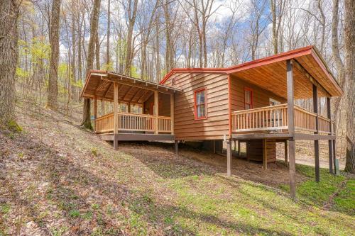 a large wooden cabin in the woods with trees at Wyandot Woods - Lake House in Laurelville