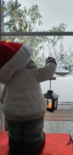 a statue of a santa hat sitting next to a lamp at Apartma Tomažič in Hrušica