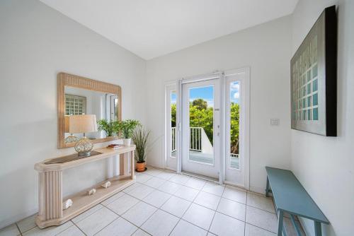a room with a table and a mirror and a window at Palm Whisper in Sanibel