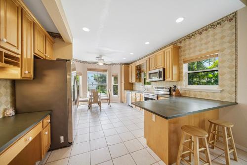 a kitchen with wooden cabinets and a black counter top at Palm Whisper in Sanibel