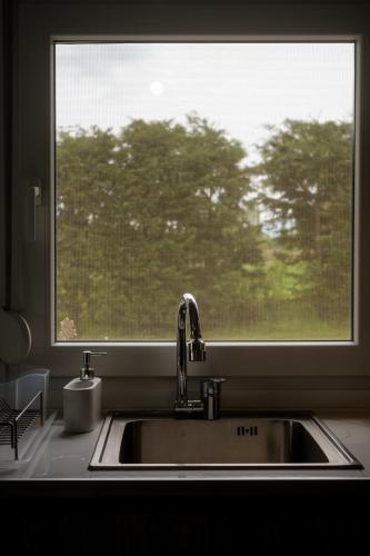 a kitchen sink in front of a window at Casa Montagna in Florina