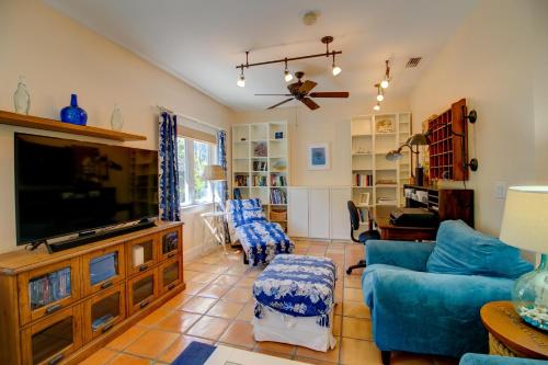 a living room with a blue couch and a tv at Whimsea in Sanibel