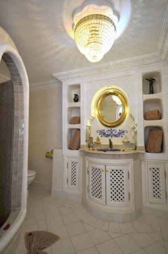 a bathroom with a sink and a mirror at Riad Palais Des Princesses & Spa in Marrakesh