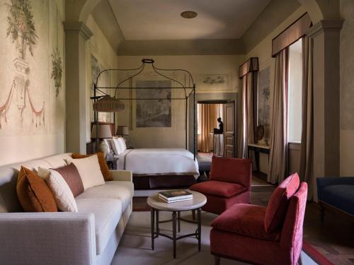 a living room with a couch and a bed at Collegio alla Querce, Auberge Collection in Florence