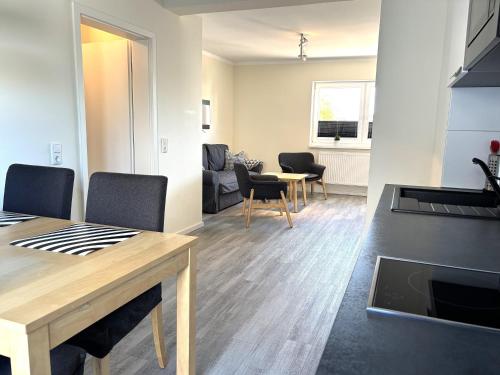 a kitchen and living room with a table and chairs at 2013 FeWo Schauf Whg4 in Dahme