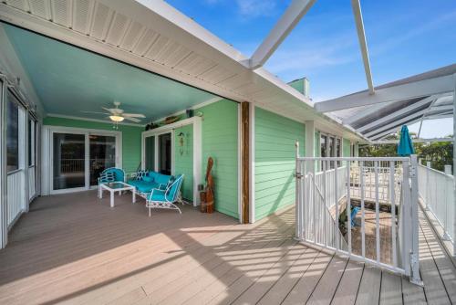 a porch of a green house with a table and chairs at The Turtle Nest in Sanibel