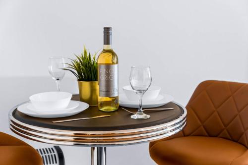 a bottle of wine sitting on a table with glasses at Modern Apartment - City Centre - Smart TV & Netflix 302Q in Birmingham
