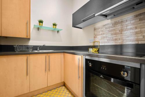 a kitchen with a sink and a dishwasher at Modern Apartment - City Centre - Smart TV & Netflix 302Q in Birmingham