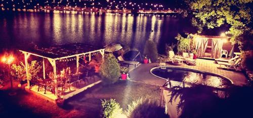 an aerial view of a house on the water at night at CHALET Orsova in Orşova