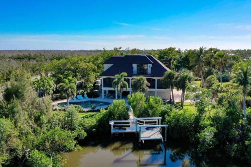 an aerial view of a house with a pond at Dockside Dream at Ding Darling in Sanibel